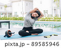 Happy asian woman stretching exercise and yoga workout in the morning at home Happy asian woman stretching exercise and yoga workout in the morning at home 89585946