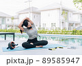 Happy asian woman stretching exercise and yoga workout in the morning at home Happy asian woman stretching exercise and yoga workout in the morning at home 89585947