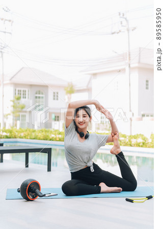 Happy asian woman stretching exercise and yoga workout in the morning at home 89585950