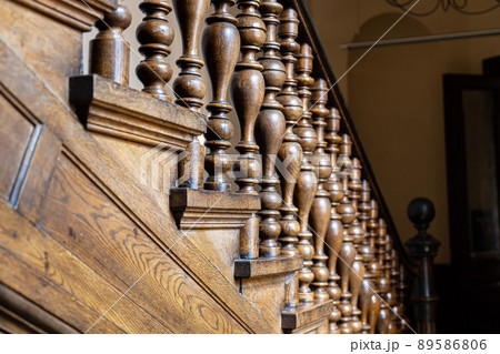 Wooden old decorative balusters, Ancient wooden stairs. decorative railings carved from wood Wooden old decorative balusters, Ancient wooden stairs. decorative railings carved from wood 89586806
