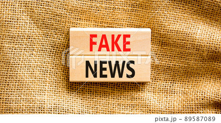 Fake news symbol. Wooden blocks with concept words Fake news on beautiful canvas background. Business media and fake news concept. Copy space. 89587089