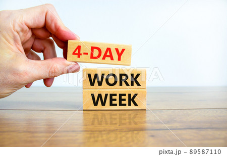 4-day work week symbol. Concept words 4-day work week on wooden blocks on beautiful white background. Businessman hand. Copy space. Business and 4-day work week and short workweek concept. 89587110