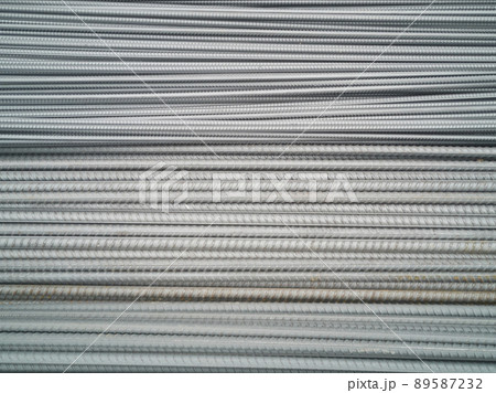 Closeup of concrete reinforcement steel rods in warehouse. Steel rods or bars used to reinforce concrete Steel rod. Construction steel. Ribbed iron bars waiting to be shaped and used for construction. Closeup of concrete reinforcement steel rods in warehouse. Steel rods or bars used to reinforce concrete Steel rod. Construction steel. Ribbed iron bars waiting to be shaped and used for construction. 89587232