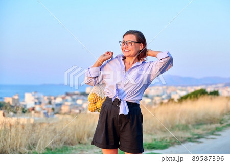 Happy woman enjoying summer sunset in mountain sea nature 89587396