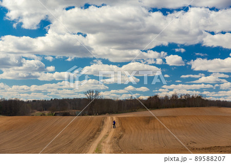 The man on bicycle is a photographer in the field 89588207