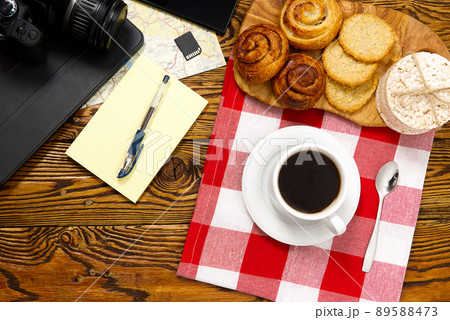 light breakfast, fresh pastries and coffee, on an old wooden table. tourist concept. Travel blogger breakfast building a route plan with cup of coffee light breakfast, fresh pastries and coffee, on an old wooden table. tourist concept. Travel blogger breakfast building a route plan with cup of coffee 89588473