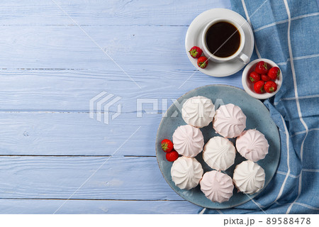 Good morning banner. Cup of coffee and homemade dessert zephyr, Zefir on light blue wood background. Top view. Food Photography with copy space Good morning banner. Cup of coffee and homemade dessert zephyr, Zefir on light blue wood background. Top view. Food Photography with copy space 89588478