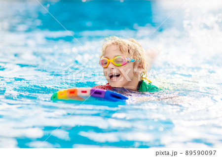Child learning to swim. Kids in swimming pool. Child learning to swim. Kids in swimming pool. 89590097