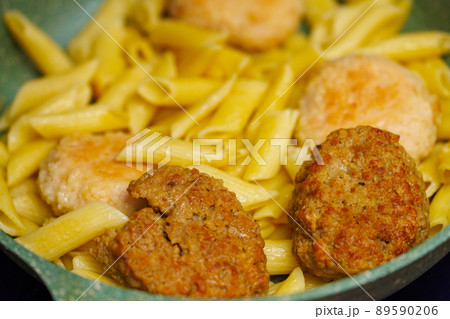 pasta with meatballs in skillet, close-up 89590206
