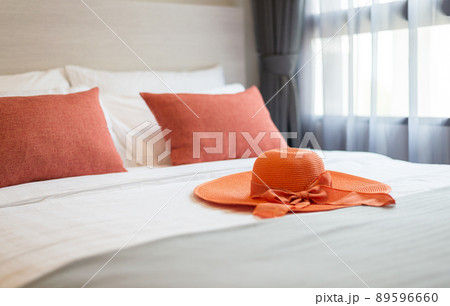 Orange pillows on the bed 89596660