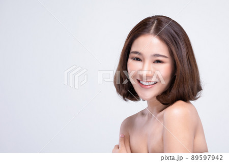 Beautiful Asian woman looking at camera smile with clean and fresh skin Happiness and cheerful with positive emotional isolated on white background.Beauty and Cosmetics Concept.Well-being self care 89597942