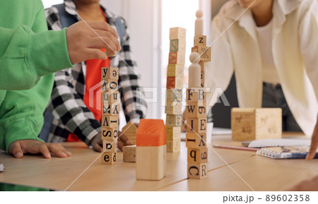 African American teacher and student doing activity playing block wooden for development together with enjoy and fun in the classroom. 89602358
