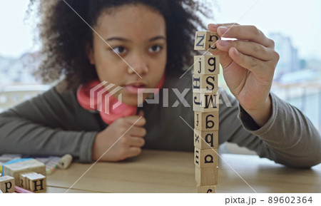 African American student doing activity playing block wooden for development together with enjoy and fun in the classroom. 89602364