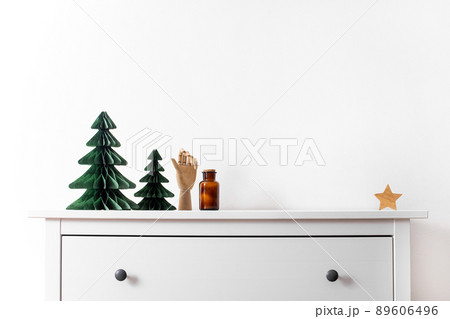Trendy decorative Christmas trees, which made of paper with blurred house background, DIY project, Organic Modern Design, Hanging Festive Honeycomb Foldable 3D tree 89606496