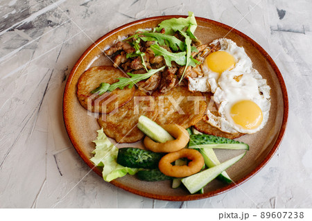 Delicious potato puncakes served with fried eggs. 89607238