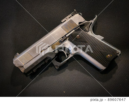 Old and dirty pistol gun on the fabric background Old and dirty pistol gun on the fabric background 89607647