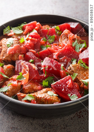 Braised beef with beets and onions in a spicy sauce close-up in a bowl. vertical Braised beef with beets and onions in a spicy sauce close-up in a bowl. vertical 89608637