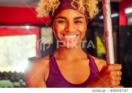 sporty african american woman pull-up athletic iron indoors 89609787