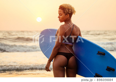 brazilian american woman with board at sunset feeling relax brazilian american woman with board at sunset feeling relax 89609884