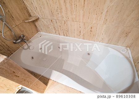 Empty and old jacuzzi bath tube in bathroom interior of a flat Empty and old jacuzzi bath tube in bathroom interior of a flat 89610308
