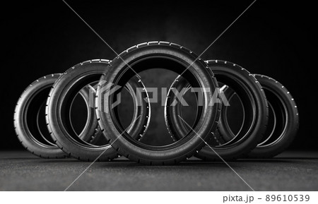 Five car tires on the asphalt on a black background. 3D rendering illustration. Five car tires on the asphalt on a black background. 3D rendering illustration. 89610539
