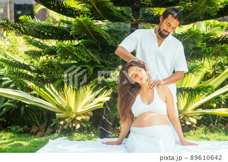 outdoor tropics beach spa centre.pregnant woman getting relax massage in tropical garden outdoor tropics beach spa centre.pregnant woman getting relax massage in tropical garden 89610642