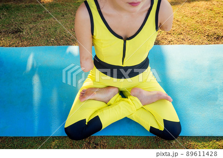 happy asian armless woman warming up before swimming at the tropical beach on yoga mat happy asian armless woman warming up before swimming at the tropical beach on yoga mat 89611428