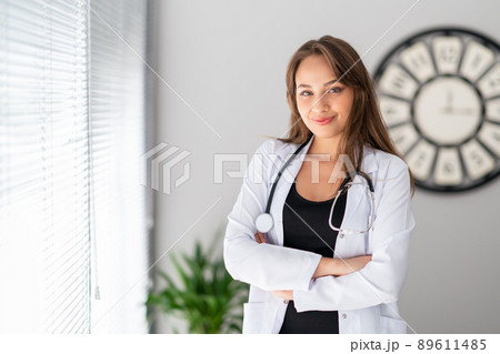 A attractive female doctor is looking with, confidence and pretty smile . A attractive female doctor is looking with, confidence and pretty smile . 89611485