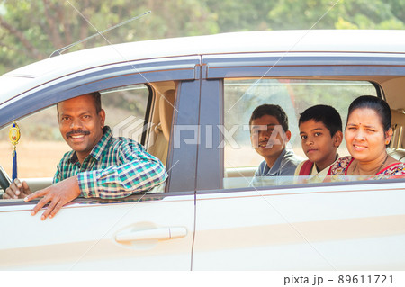 indian family buying a new car and ready to go on beach vacation 89611721