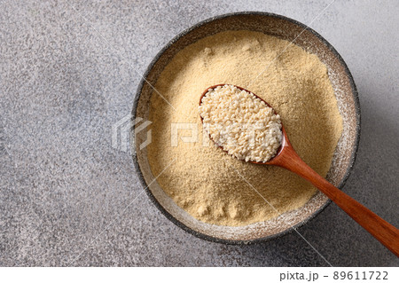 Sesame flour in bowl for cooking vegan gluten-free dessert. 89611722