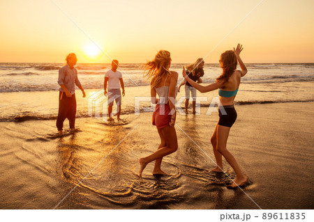 multicultural multinational happy people running into the sun carefree and happiness, vacation on sea multicultural multinational happy people running into the sun carefree and happiness, vacation on sea 89611835