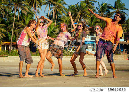 multinational multicultural mixed race friends in holi dust on beach in Goa multinational multicultural mixed race friends in holi dust on beach in Goa 89612036