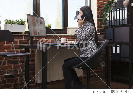 Business research company accountant talking on phone with project manager about marketing strategy. Office assistant informing management board about agency financial issue. Business research company accountant talking on phone with project manager about marketing strategy. Office assistant informing management board about agency financial issue. 89612442