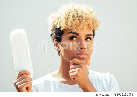 mixed race hispanic brazilian girl holding hygiene pad in studio white background and snow-white smile mixed race hispanic brazilian girl holding hygiene pad in studio white background and snow-white smile 89612603