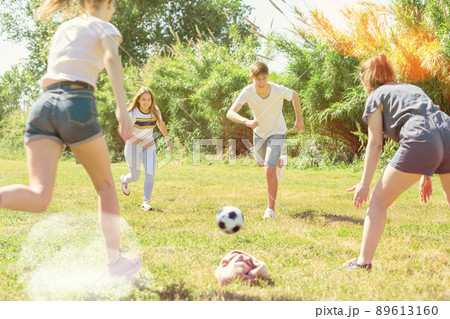 Teenagers play street football with excitement in park Teenagers play street football with excitement in park 89613160