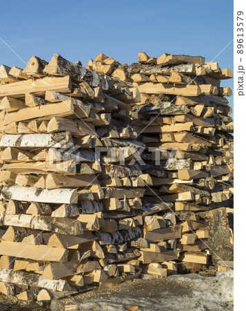 Pricked firewood built in stack of logs on background blue sky Pricked firewood built in stack of logs on background blue sky 89613579