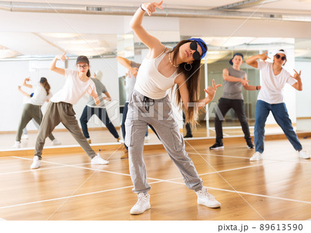 Teenagers boy and girls performing hip hop at group class Teenagers boy and girls performing hip hop at group class 89613590