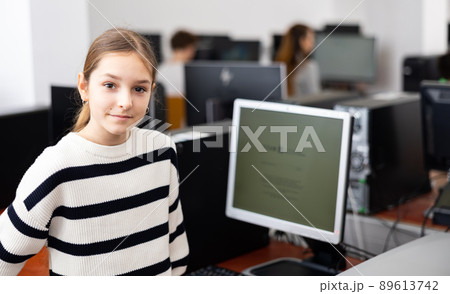 Portrait of young girl in computer class Portrait of young girl in computer class 89613742