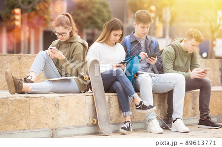 Teenage friends holding phones 89613771