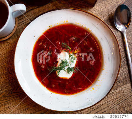 Plate of red borscht garnished with dill and smetana Plate of red borscht garnished with dill and smetana 89613774