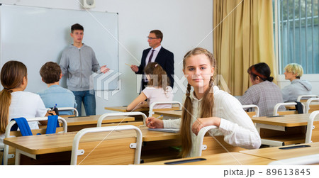 Portrait of girl who is posing at the desk in class 89613845