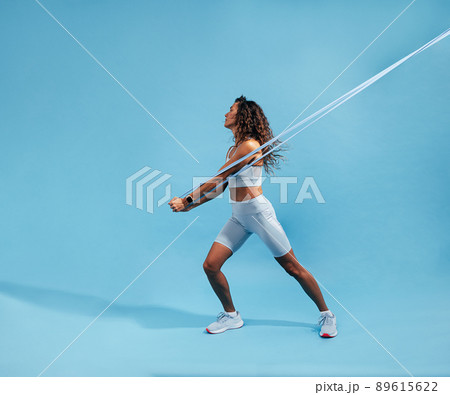 Fitness woman doing resistance workout. Young female doing core strength training.	 89615622