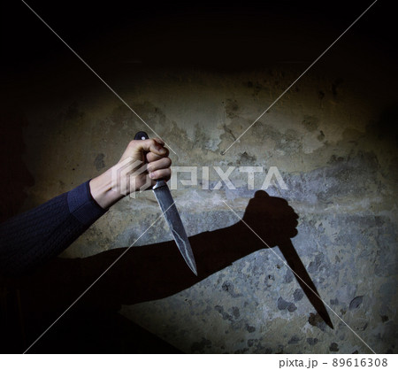 Shadow of the hand holding a big knife 89616308