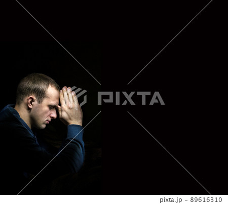 Young man praying Young man praying 89616310
