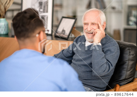Happy elderly person talking to his in-home caregiver 89617644