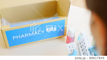 asian pharmacist pack medication 89617849