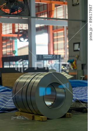Roll of steel sheet in a plant. Rolls of sheet steel of Factory. Coils of steel stripes in store Roll of steel sheet in a plant. Rolls of sheet steel of Factory. Coils of steel stripes in store 89617987