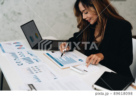 usiness analyzing investment charts with calculator laptop. Accounting and technology in office.Business people using laptop at office,Analyze plans.selective focus. usiness analyzing investment charts with calculator laptop. Accounting and technology in office.Business people using laptop at office,Analyze plans.selective focus. 89618098