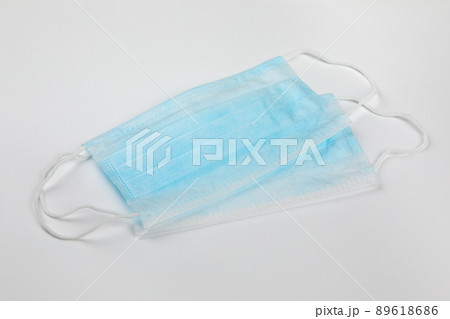 two blue surgical medical masks on white background 89618686