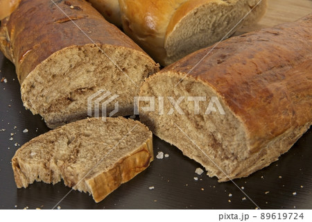 Bread in the shape of a braid. Sweet Challah. Slice of banana bread for breakfast, side view. Cherry tomatoes Bread in the shape of a braid. Sweet Challah. Slice of banana bread for breakfast, side view. Cherry tomatoes 89619724